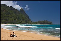 Woman sitting on a beach chair on Makua (Tunnels) Beach. North shore, Kauai island, Hawaii, USA (color)