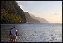 Couple standing in water, Kee Beach, late afternoon. Kauai island, Hawaii, USA