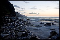 Boulders, waves, and Na Pali Coast, sunset. North shore, Kauai island, Hawaii, USA