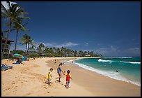 Children playing around, Kiahuna Beach, mid-day. Kauai island, Hawaii, USA