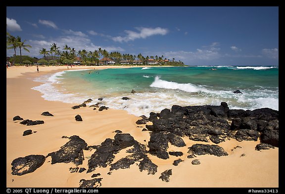 Dark rocks and Kiahuna Beach, mid-day. Kauai island, Hawaii, USA (color)