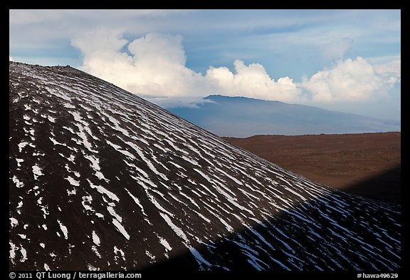 Cinder cone with snow stripes, distant clouds. Mauna Kea, Big Island, Hawaii, USA