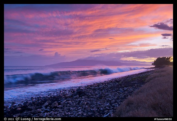Crashing wave, Lanai Island, and colorful sunset clouds. Lahaina, Maui, Hawaii, USA