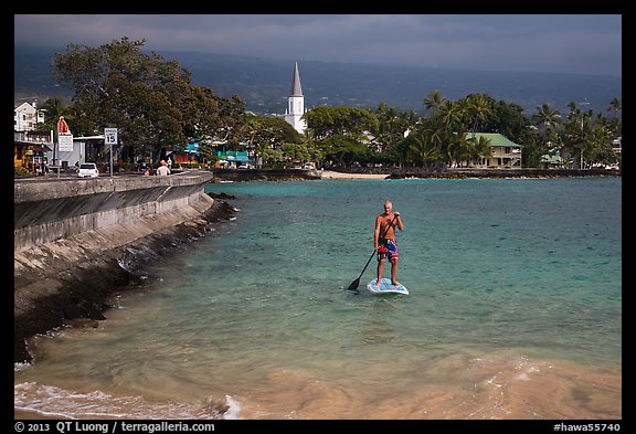 Paddlesurfer and Kailua-Kona. Hawaii, USA