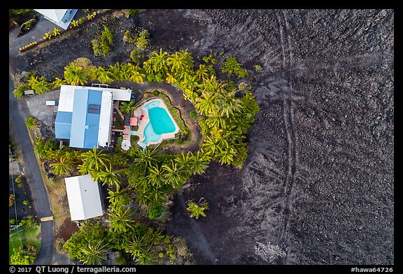 Aerial view of house and pool on edge of lava field. Big Island, Hawaii, USA