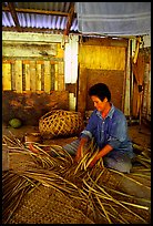 Woman weaving a toga (mat) out of pandamus leaves. American Samoa (color)