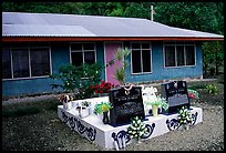 Tombs in front of a home in Faleasao. American Samoa (color)