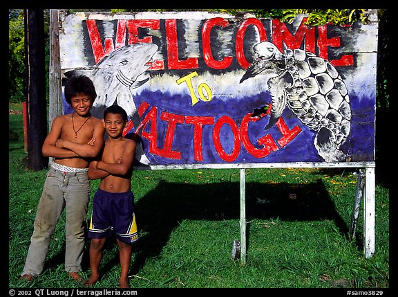Children in front of a turtle a shark sign in Vaitogi. Tutuila, American Samoa (color)