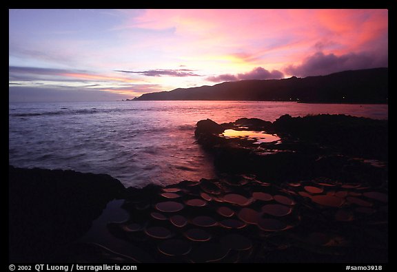 Ancient grinding stones (foaga) and Leone Bay at sunset. Tutuila, American Samoa