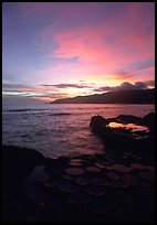 Water-filled  grinding stones holes (foaga) and Leone Bay at sunset. Tutuila, American Samoa
