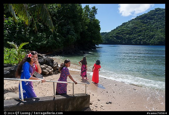 Young samoan women walking down to beach in Fagasa Bay. Tutuila, American Samoa (color)