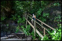 Hiker on staircase to beach, Fagatele Bay. Tutuila, American Samoa ( color)