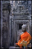 Buddha image, swathed in reverence, with offerings, the Bayon. Angkor, Cambodia (color)