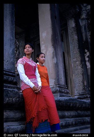 Elegant young women near temple entrance. Angkor, Cambodia (color)