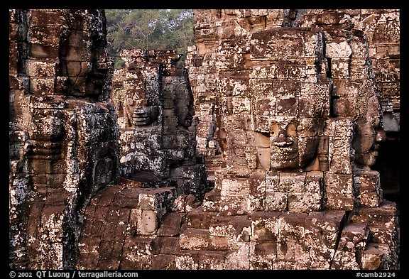Large stone smiling faces on upper terrace, the Bayon. Angkor, Cambodia