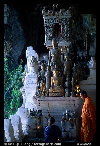 Novice Buddhist monk and vistor in Pak Ou cave. Laos
