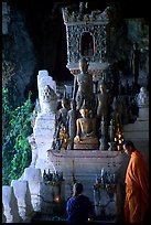 Novice Buddhist monk and vistor in Pak Ou cave. Laos ( color)