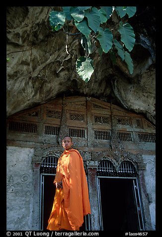 Novice Buddhist monk at entrance of lower Pak Ou cave. Laos