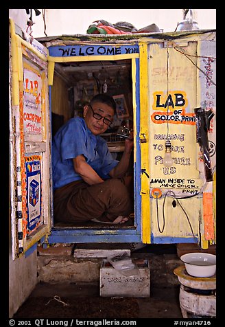 Man in one-room photo lab. Bagan, Myanmar (color)