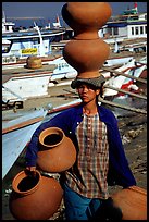 Carrying many jars. Mandalay, Myanmar (color)
