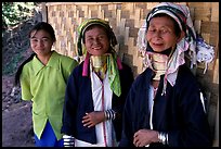 Three generations of Padaung women	along hut. Shan state, Myanmar (color)