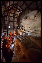 Novices praying in front of Shinbinthalyaung reclining Budddha head. Bagan, Myanmar ( color)