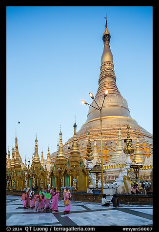 Nuns walking at the base of main chedi, Shwedagon Pagoda. Yangon, Myanmar