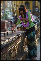 Woman lighting candles, Shwedagon Pagoda. Yangon, Myanmar ( color)