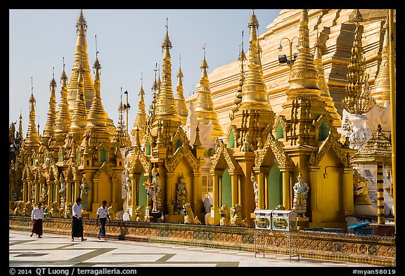 Men walking near stupas, Shwedagon Pagoda. Yangon, Myanmar
