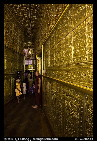 Worshippers inside maze-like walkway lined with glass showcases, Botataung Pagoda. Yangon, Myanmar (color)