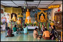 Visitors and altar, Botataung Pagoda. Yangon, Myanmar ( color)