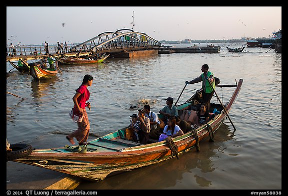 Woman boards boat to cross the Yangon River. Yangon, Myanmar (color)