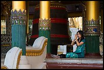 Woman praying next to bell, Shwedagon Pagoda. Yangon, Myanmar ( color)