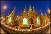 Oil lamps and stupas at dusk, Shwedagon Pagoda. Yangon, Myanmar ( color)