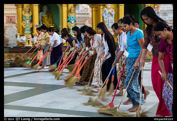 Women lining up to sweep the platform, Shwedagon Pagoda. Yangon, Myanmar