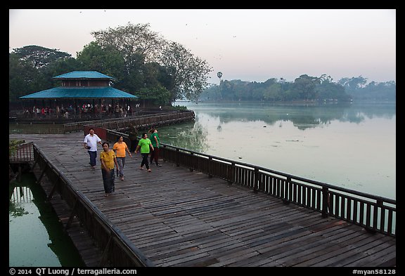 People walking for exercise at dawn, Kandawgyi Lake Park. Yangon, Myanmar (color)