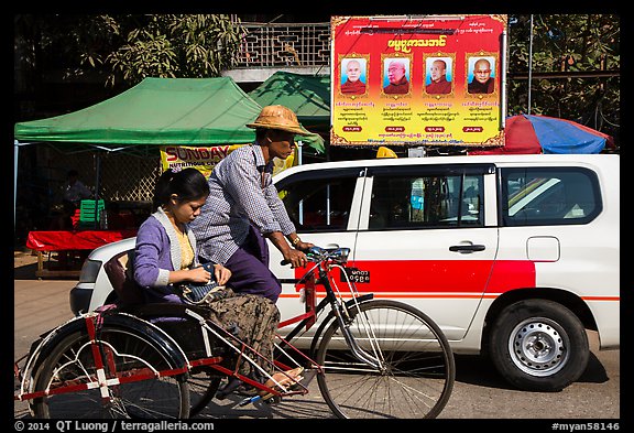 Trishaw, taxi, and billboard promoting monks. Yangon, Myanmar (color)