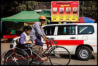Trishaw, taxi, and billboard promoting monks. Yangon, Myanmar ( color)