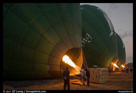 Crew inflates hot air balloons with propane burners. Bagan, Myanmar (color)