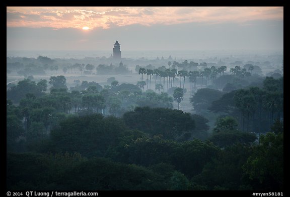 Bagan tower and sun above morning mist. Bagan, Myanmar (color)