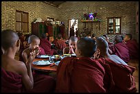 Buddhist novices pray at table before eating lunch, Nyaung U. Bagan, Myanmar ( color)