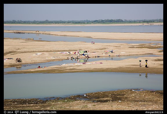 Sandy banks of Ayeyarwaddy River with villagers washing clothes. Bagan, Myanmar