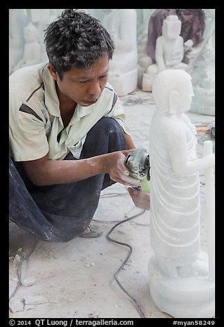 Stone sculptor finishing buddha statue. Mandalay, Myanmar (color)