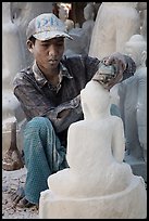Sculptor carving buddha statue out of a block of white marble. Mandalay, Myanmar ( color)