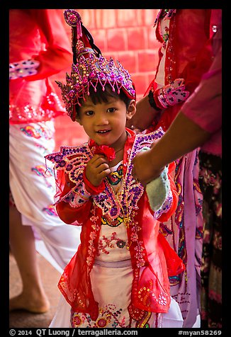 Young girl dressed in glittering attire during novitiation, Mahamuni Pagoda. Mandalay, Myanmar (color)