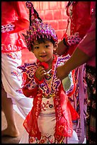 Young girl dressed in glittering attire during novitiation, Mahamuni Pagoda. Mandalay, Myanmar ( color)