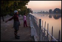 Women exercising next to Mandalay Fort at dawn. Mandalay, Myanmar ( color)