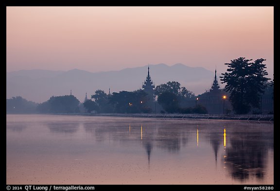 Pagodas reflected in moat at dawn, Mandalay Fort. Mandalay, Myanmar (color)