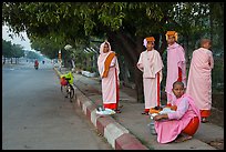 Nuns waiting for ride on sidewalk. Mandalay, Myanmar ( color)