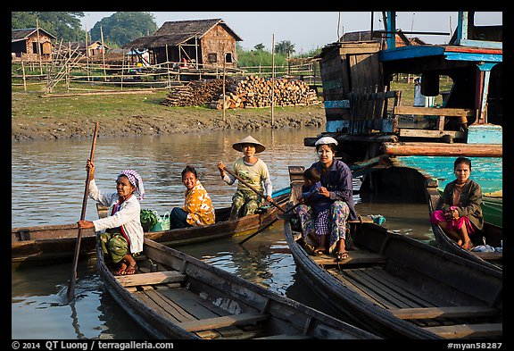 Row boats and huts on shore of Irrawaddy River. Mandalay, Myanmar (color)